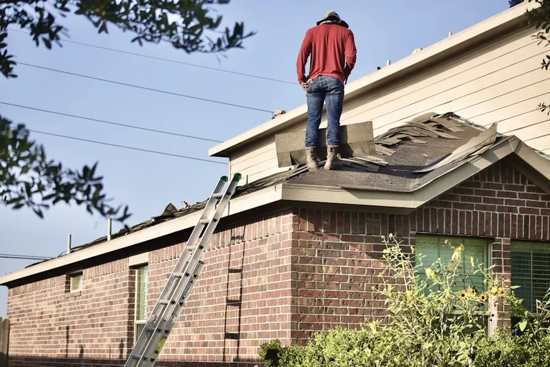 Professional roofer working on a residential roof in Sunny Side